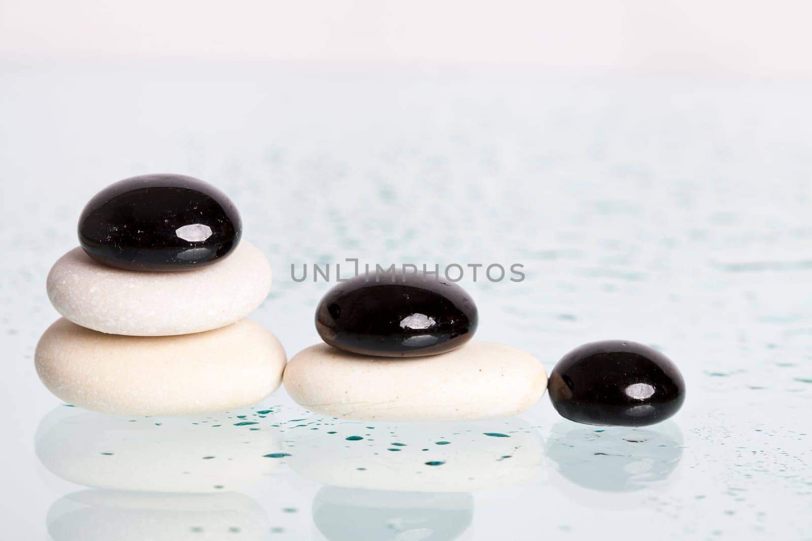 Black and white spa stones with reflection
