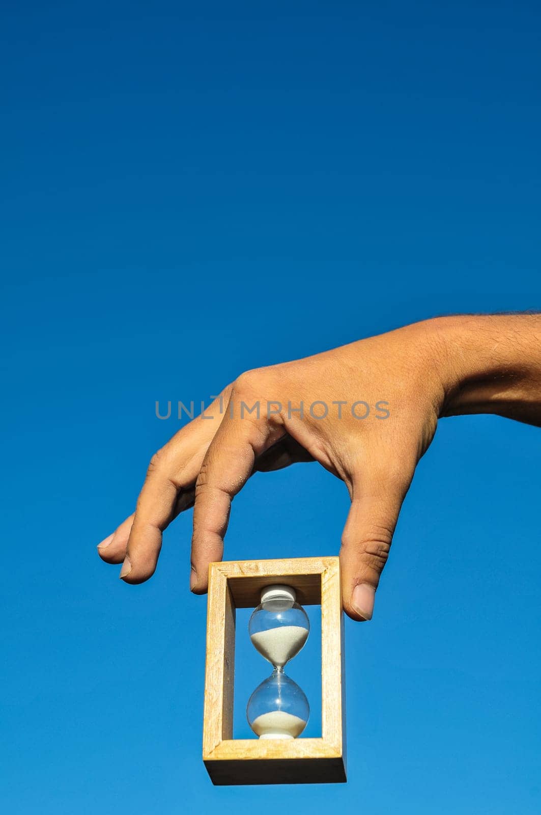 Time Concept White Sand Hourglass on the Volcanic Rocks