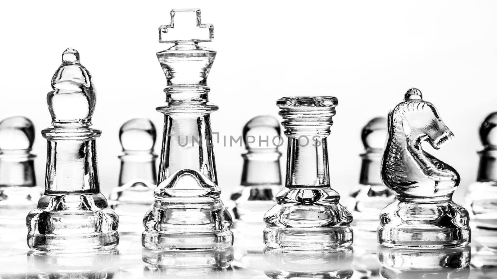bishop, king, rook and knight chess pieces made out of glass