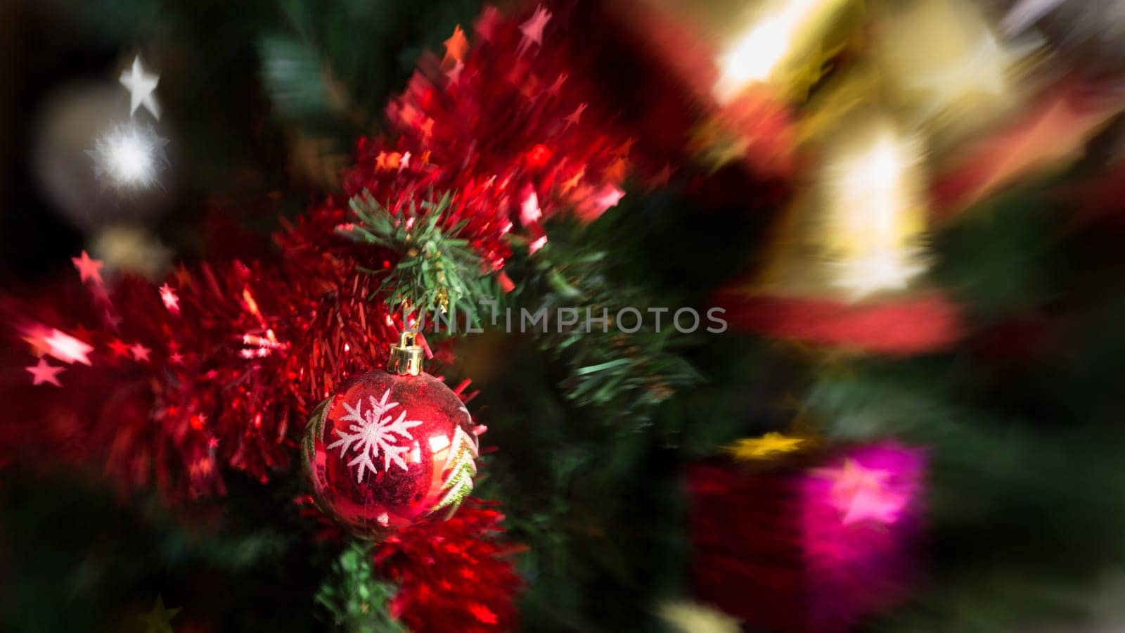 Christmas tree decoration with, lights, garland, tinsel and christmas ball