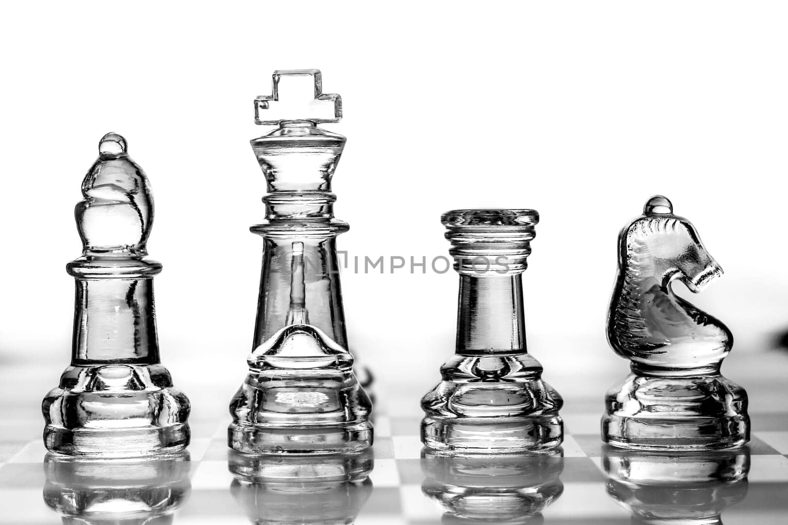 bishop, king, rook and knight chess pieces made out of glass