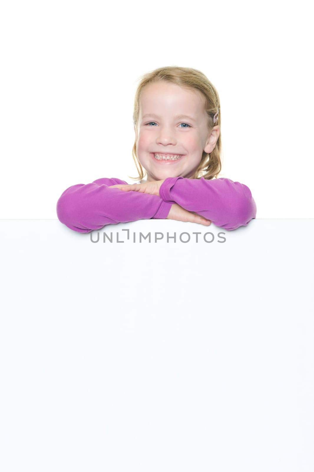 Studio recording of a happy girl with a white billboard against a white background