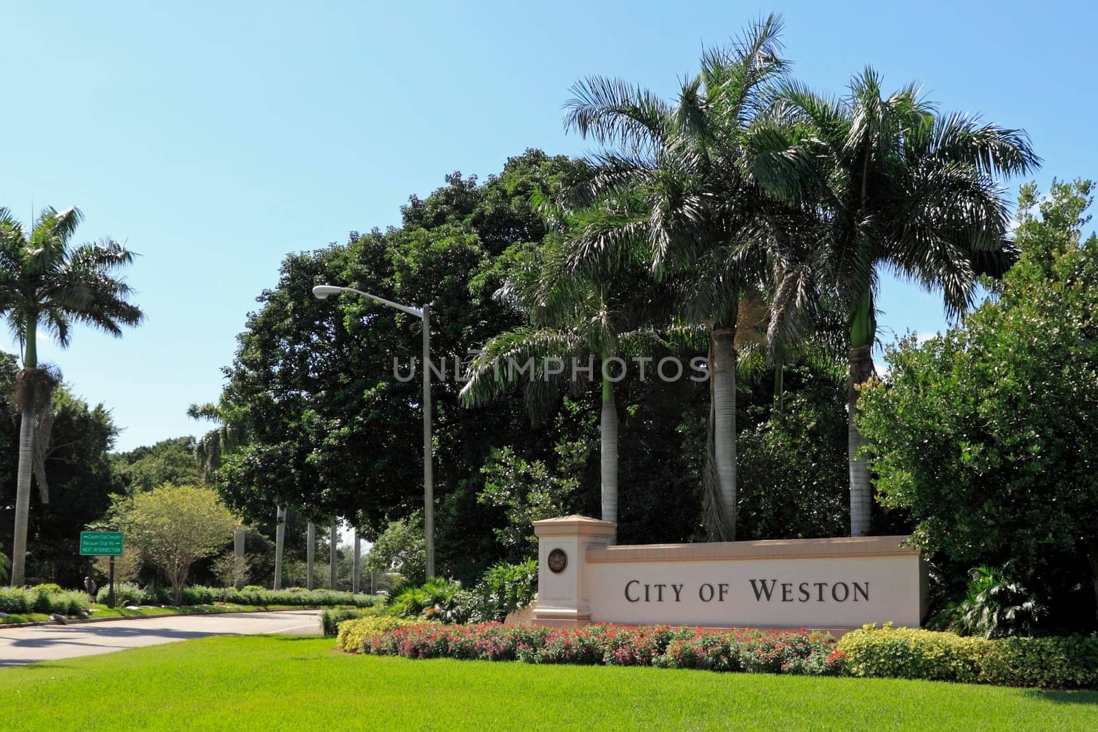 WESTON, FLORIDA - OCTOBER 22, 2013: Beautiful landscaping and flowers surround a large entrance sign to the City of Weston, located in west Broward County, population 67,641 in 2012 on a sunny day.