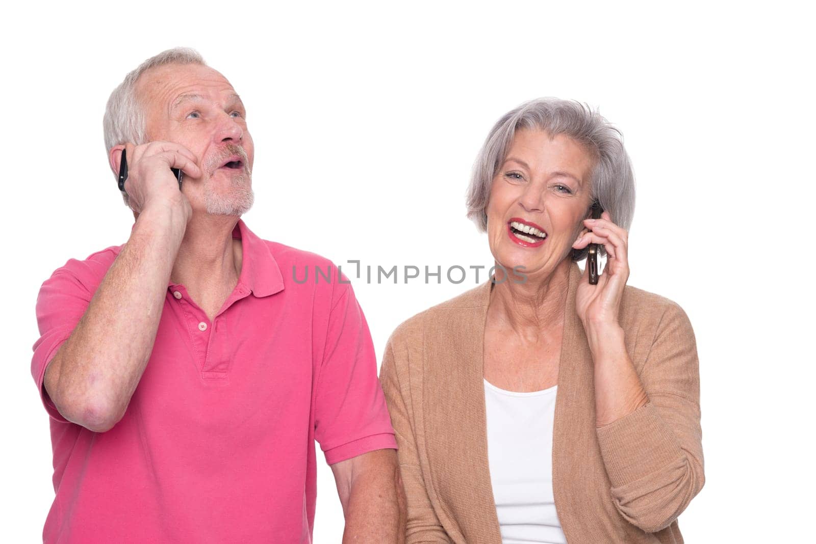 Senior couple with smartphone against a white background