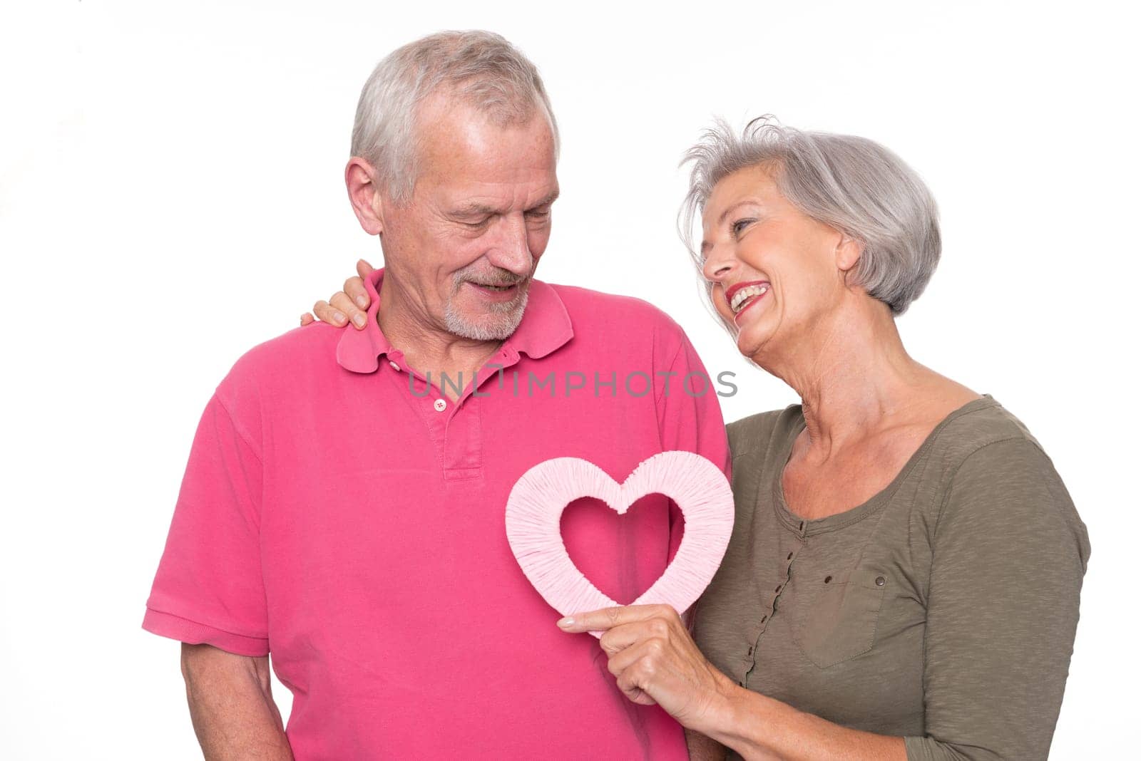 Seniors with a heart against a white background