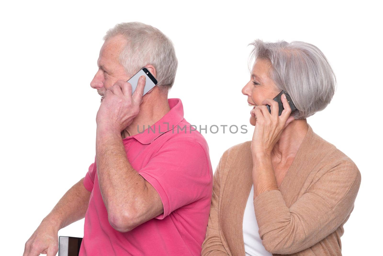 Senior couple with smartphone against a white background