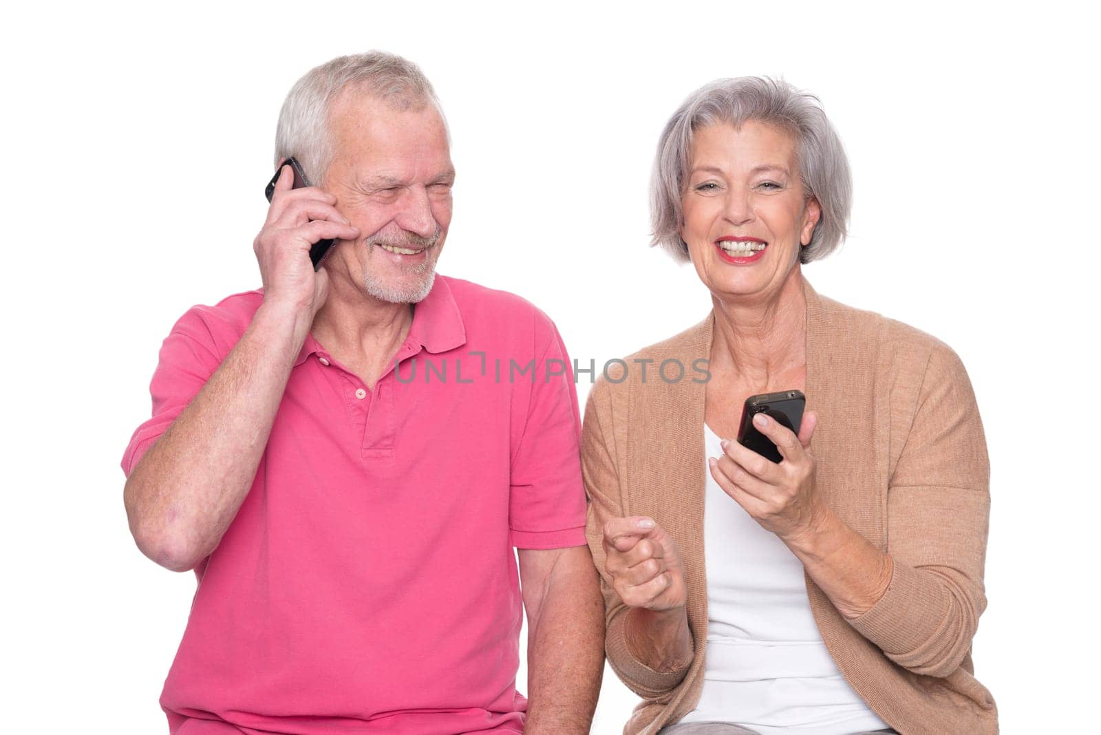 Senior couple with smartphone against a white background