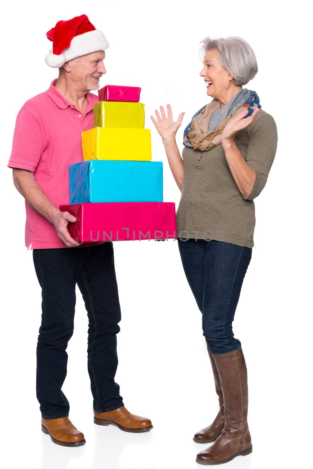 Active seniors with gifts against a white background