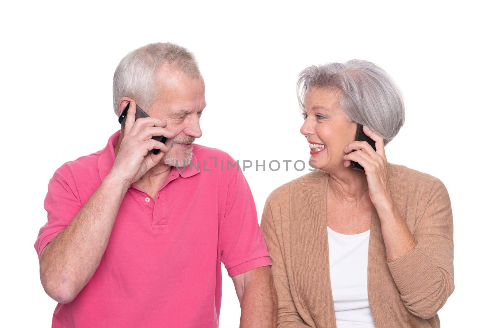 Senior couple with smartphone against a white background