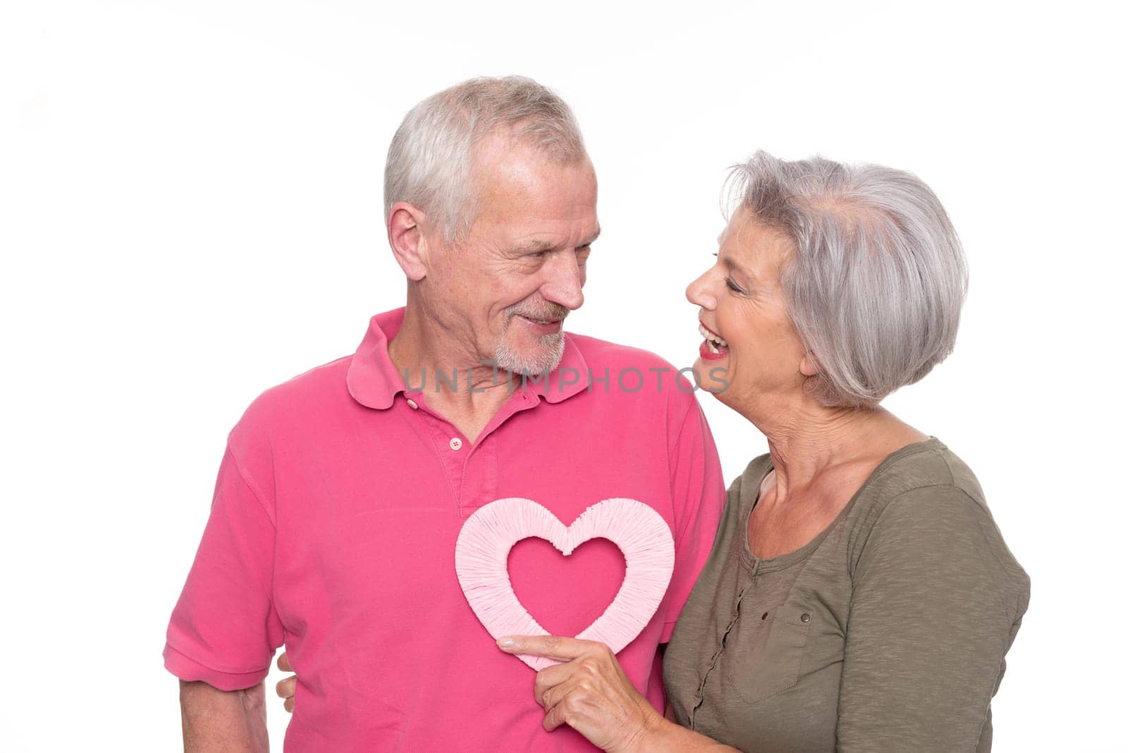Seniors with a heart against a white background