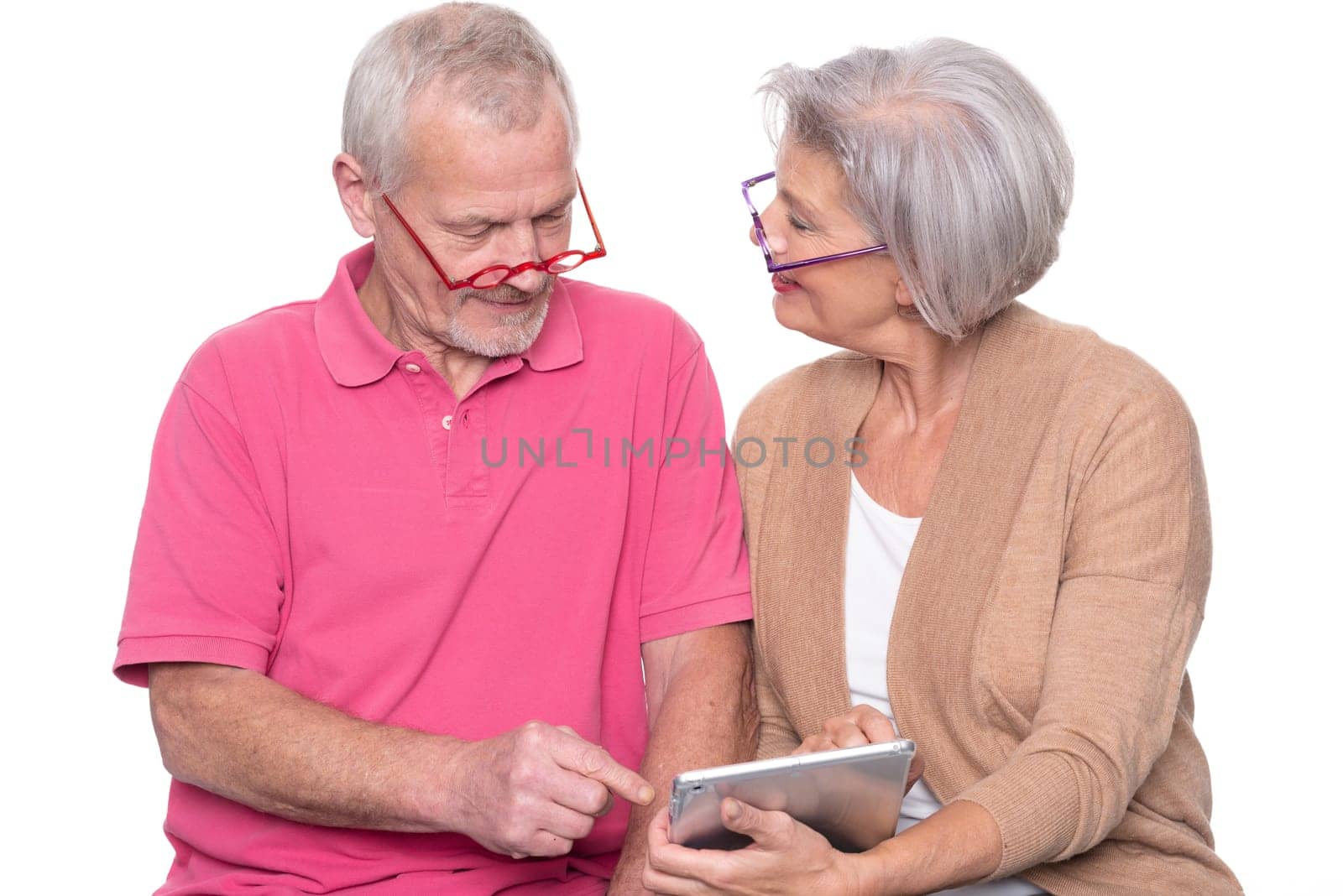 Senior couple with tablet against a white background
