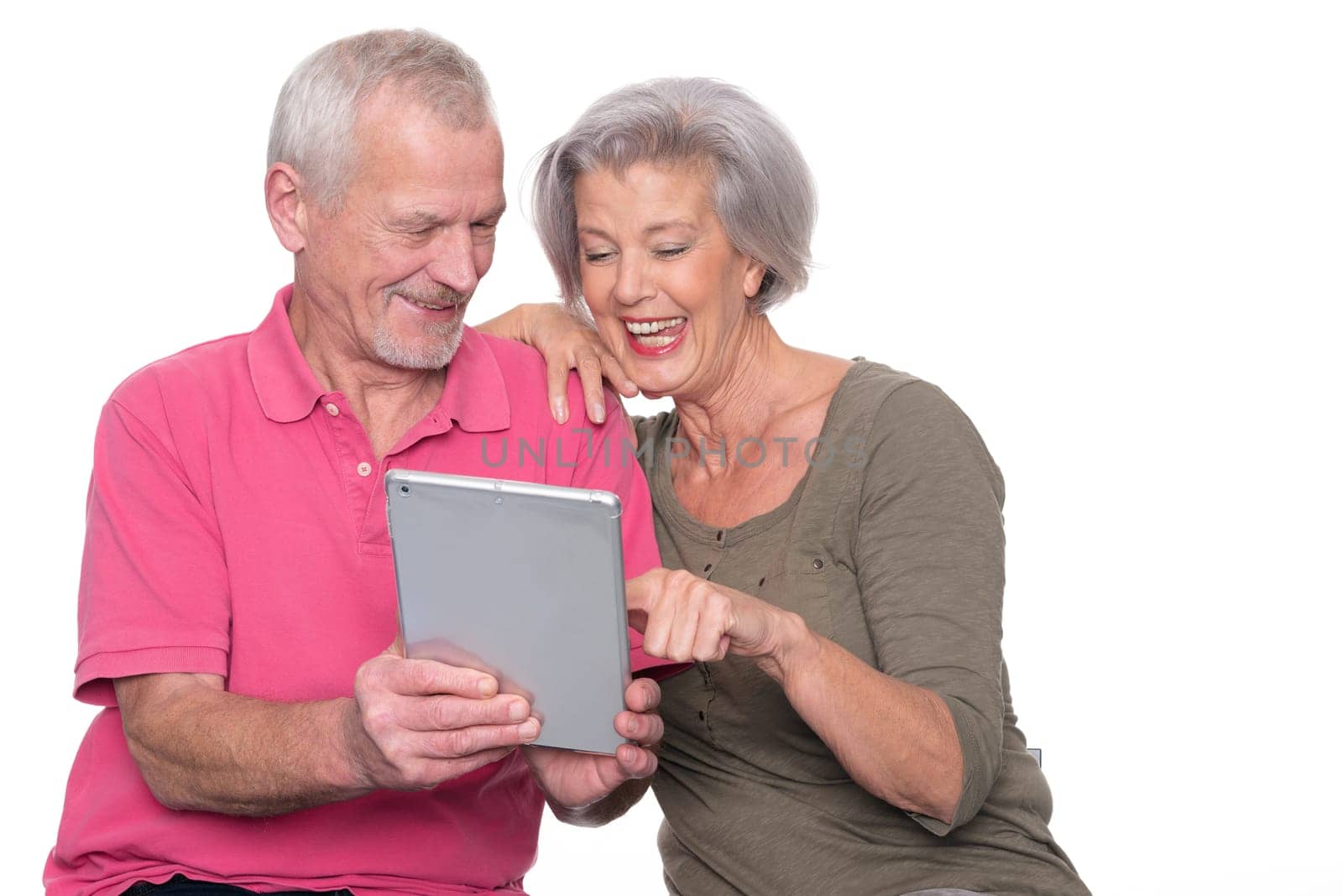 Senior couple with tablet against a white background