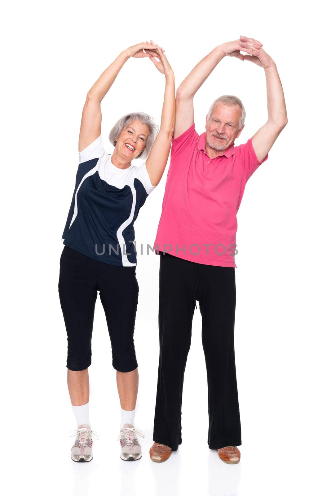 Sporty senior couple against a white background