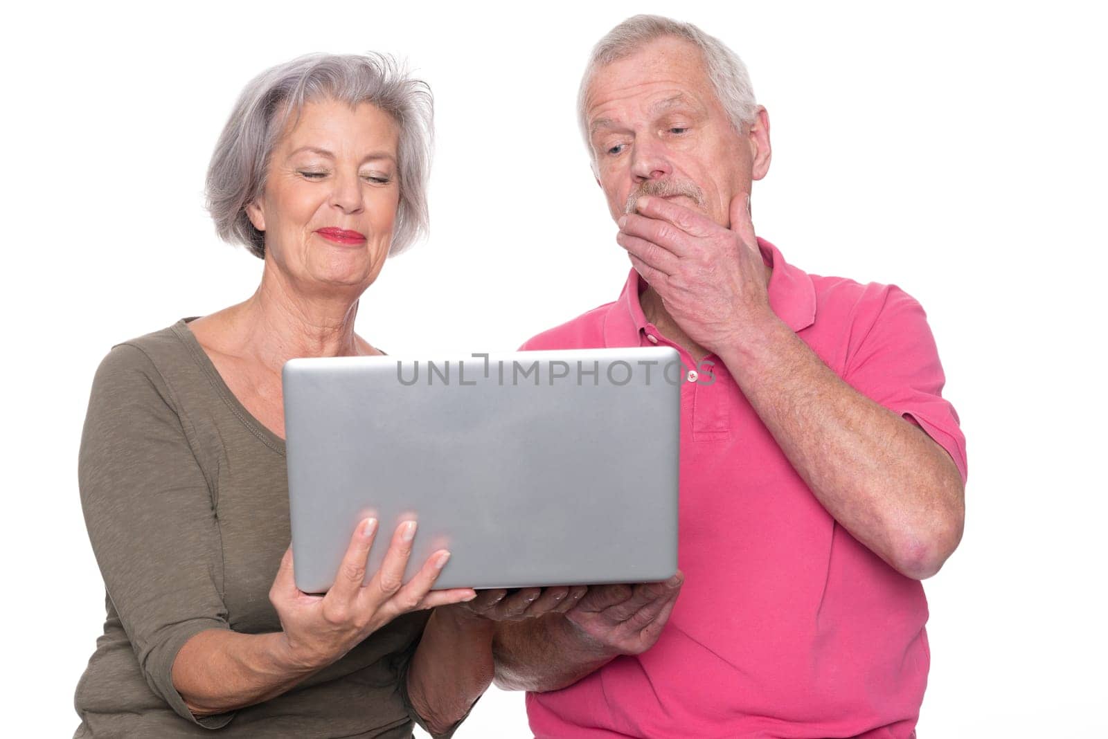 Senior couple with computer against a white background