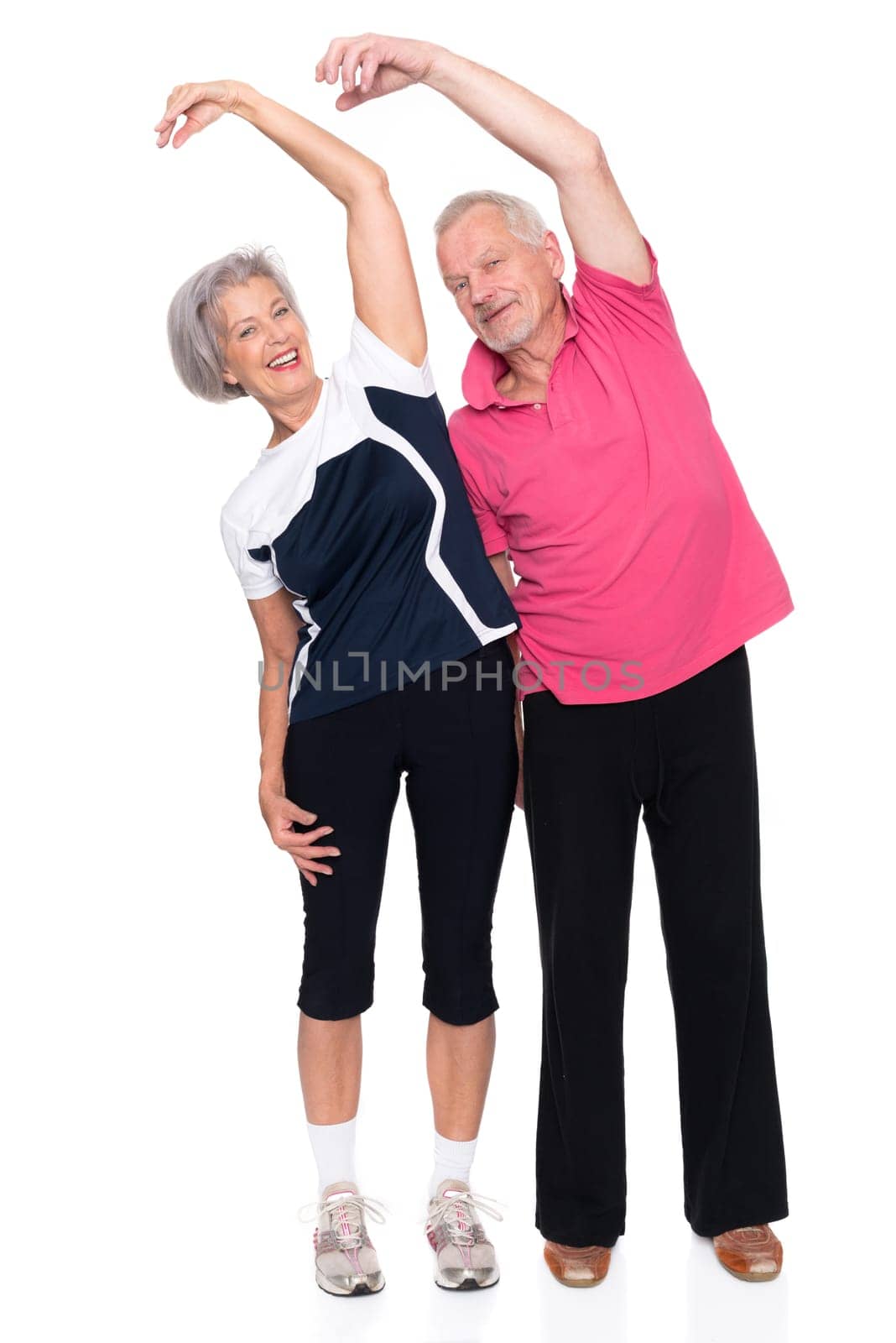 Sporty senior couple against a white background