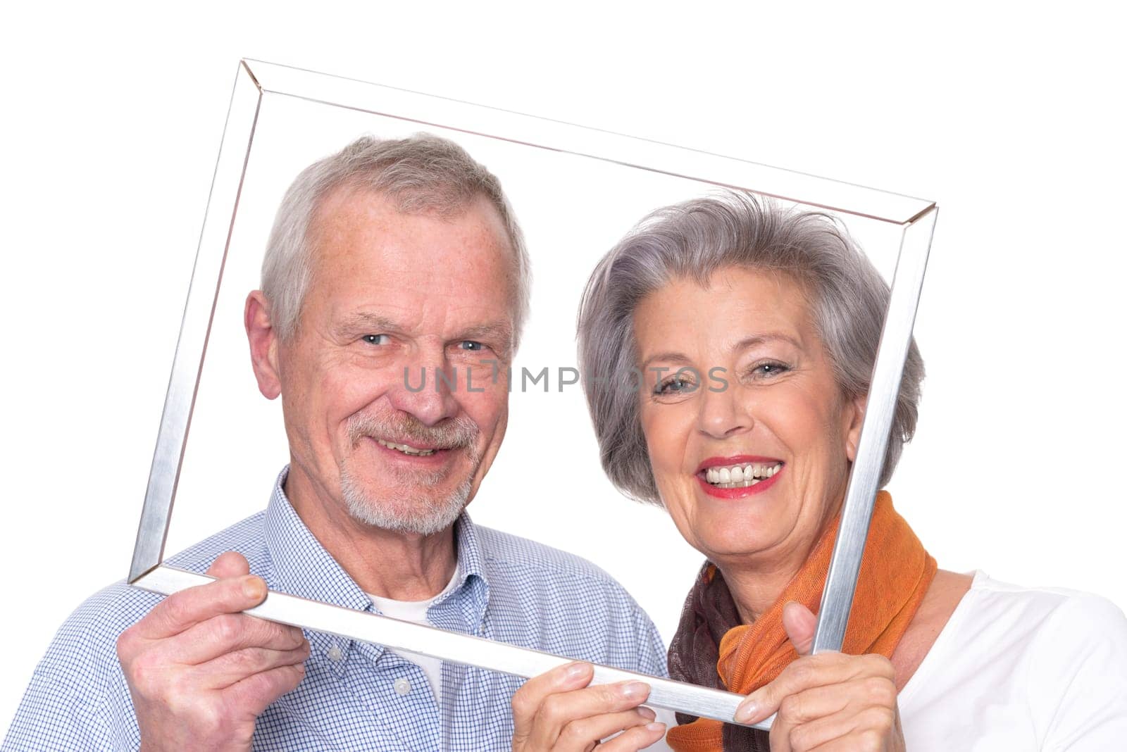 Elderly couple sees through a picture frame against a white background