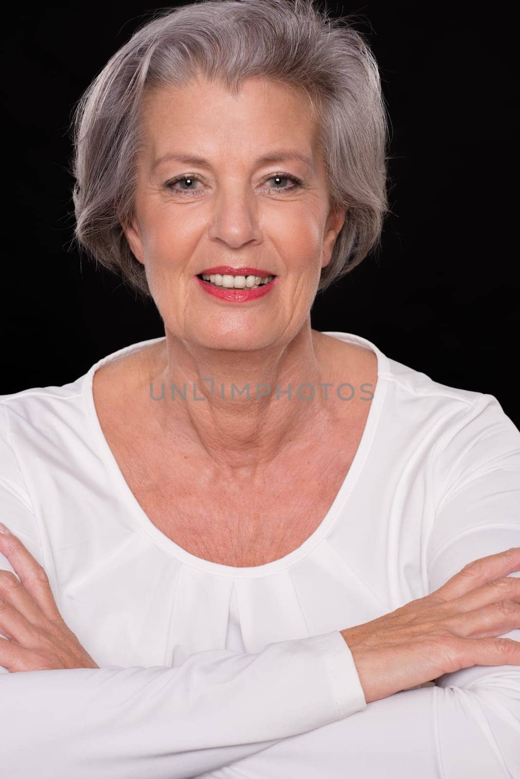 Portrait of a senior woman against a black background
