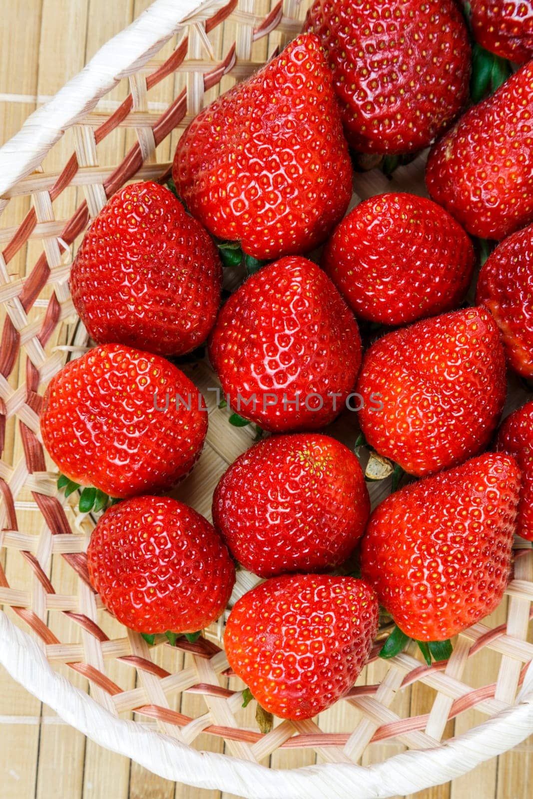 wicker basket with a group of fresh and juicy strawberries