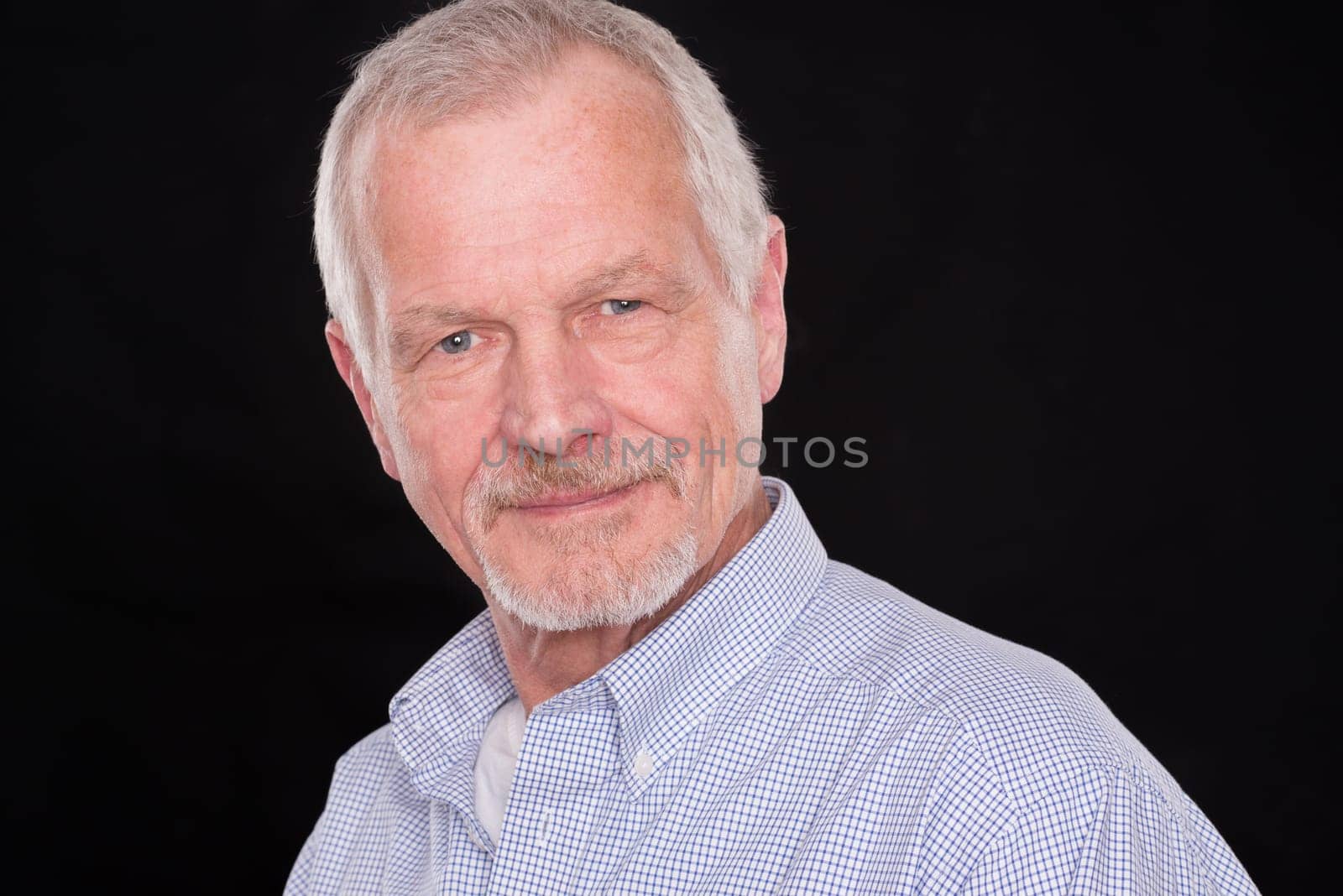 Portrait of a senior against a black background