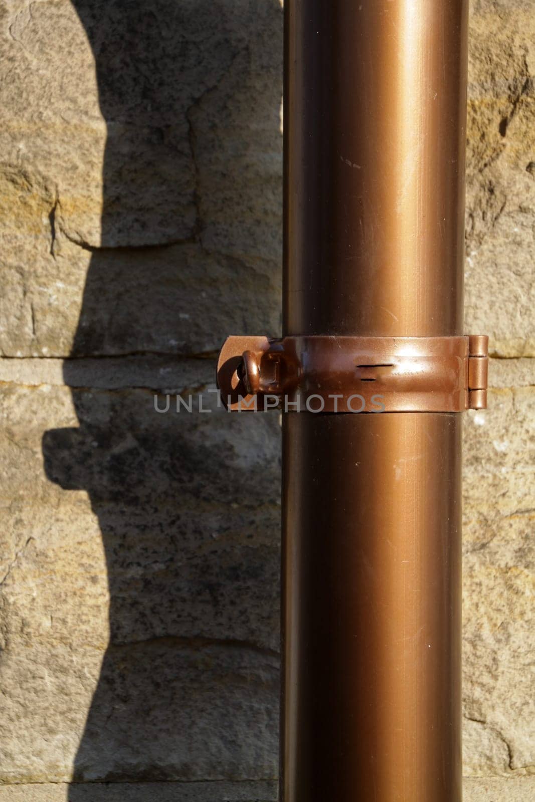 Copper drop pipe on a house wall