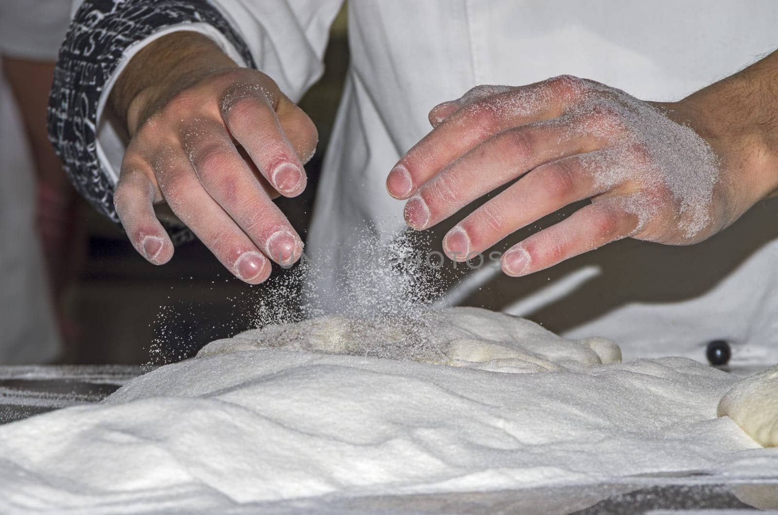 Handling, working and cooking pizza dough with shovel