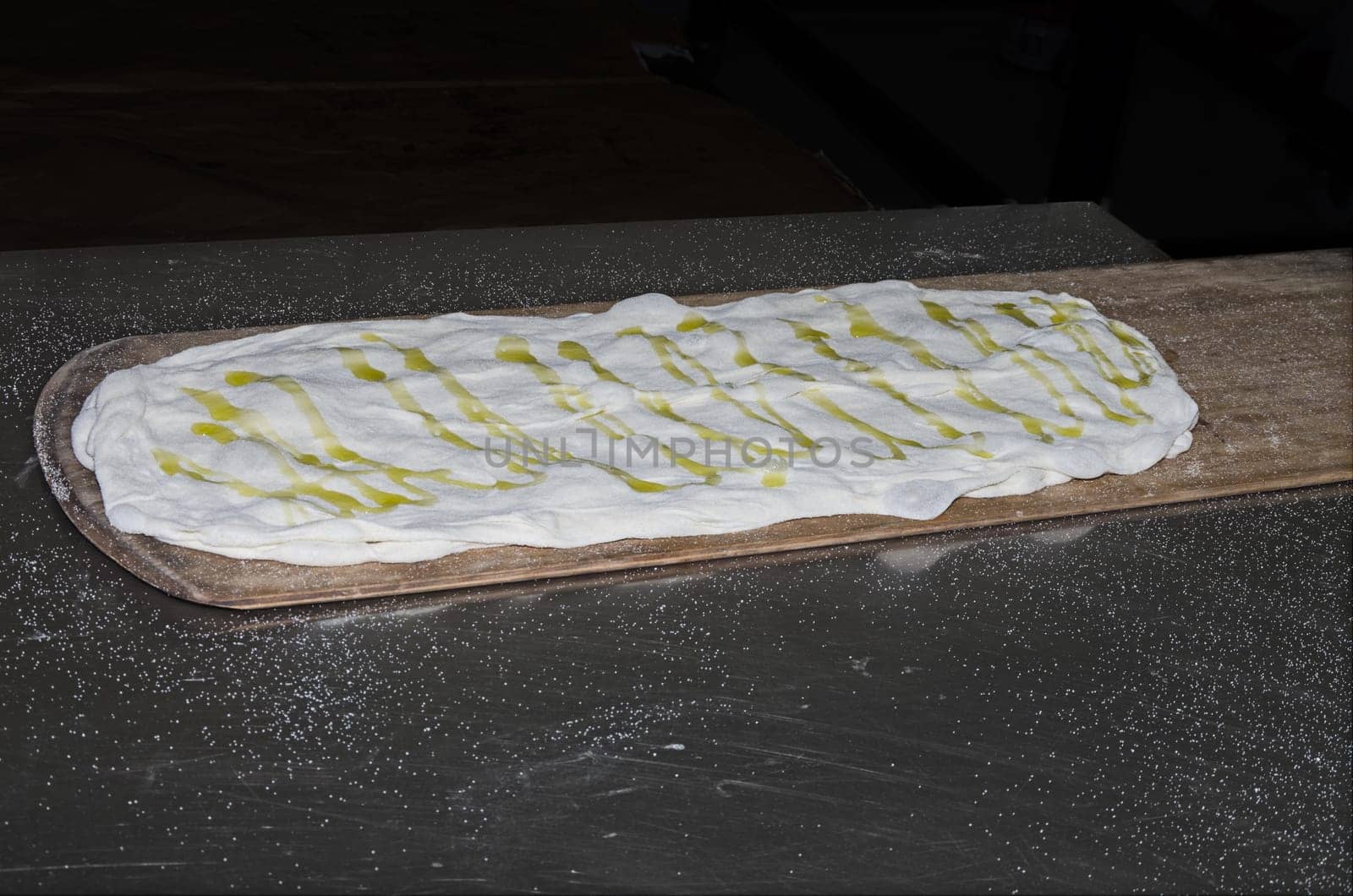 Cooking pizza dough in shovel with electric oven
