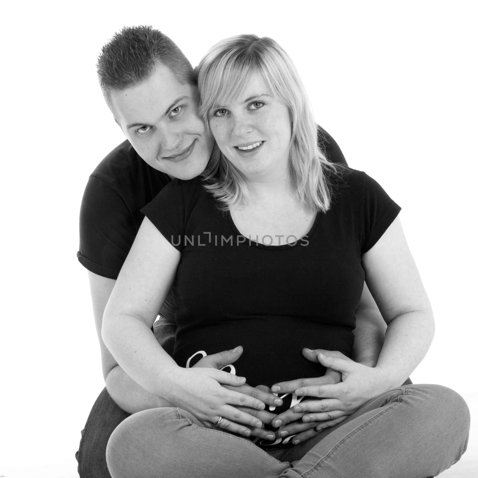 Happy young pregnant couple in the studio