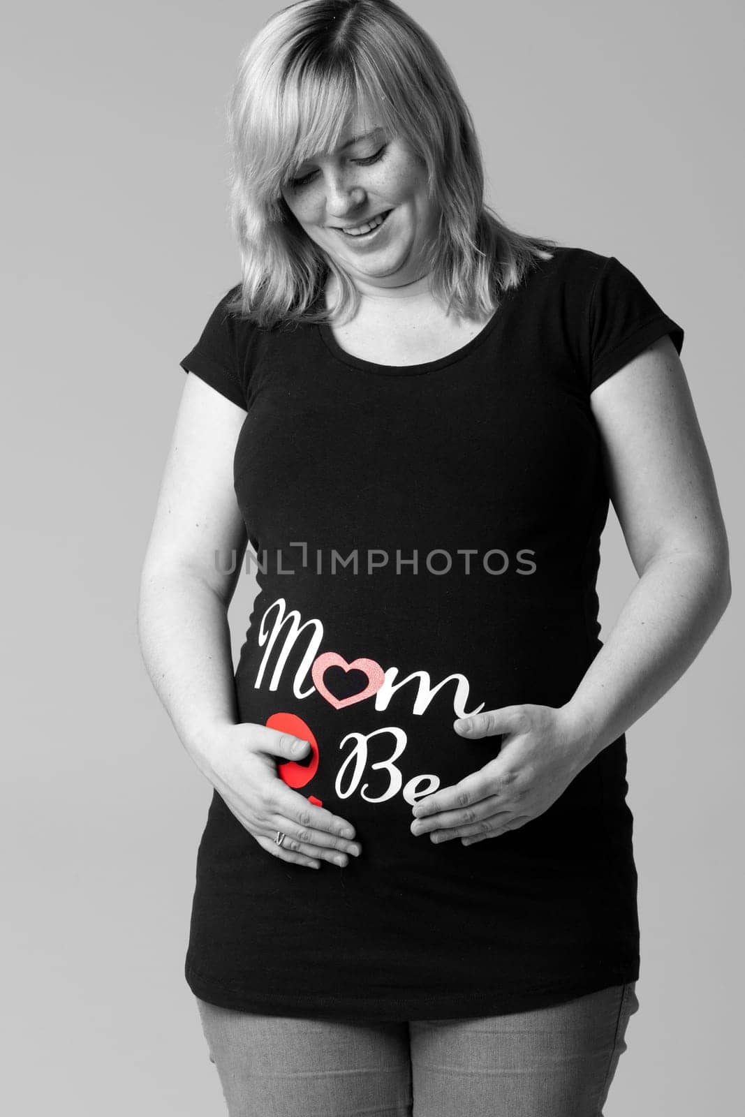 Happy young pregnant woman in the studio