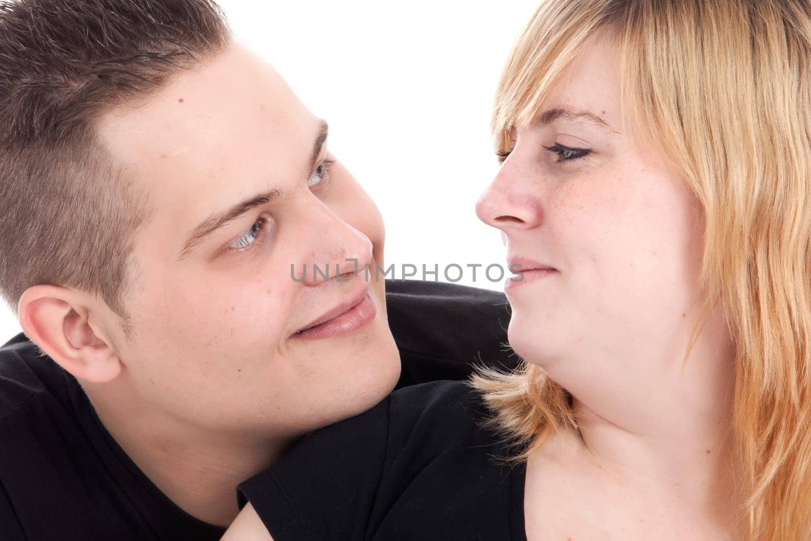 Happy young pregnant couple in the studio