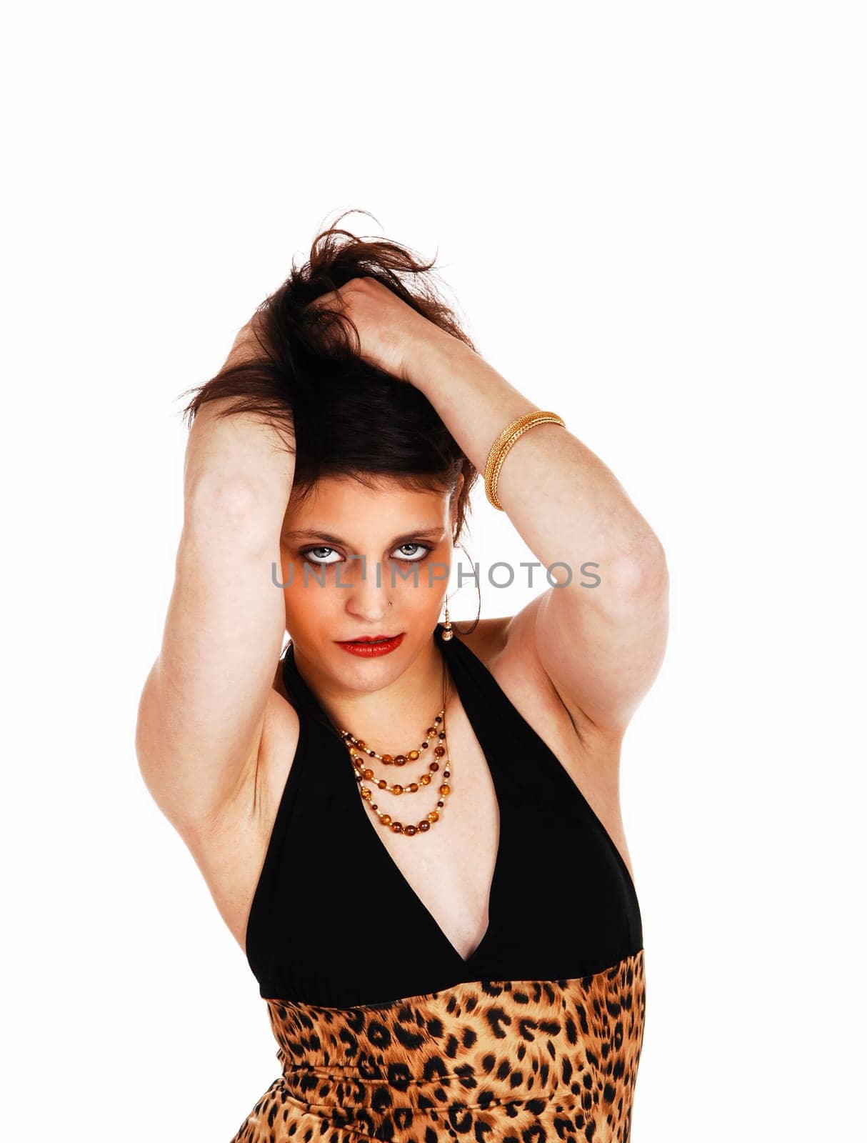 A closeup picture of a beautiful young woman with her hands in her.hair, for white background..