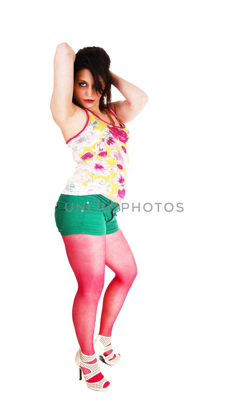 A young pretty woman in green shorts and burgundy pantyhose and.high heels standing for white background..