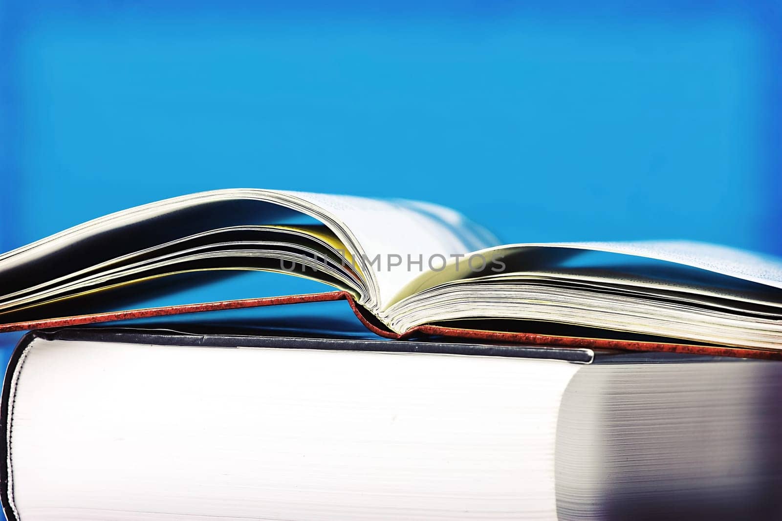 Open book in front of blue background