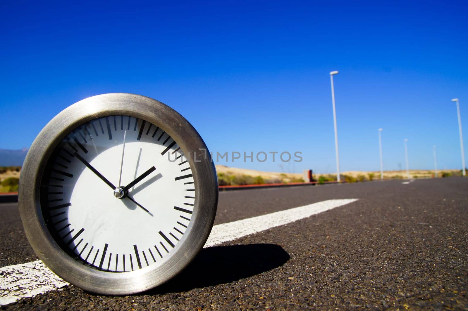 Time Concept Alarm Clock on the Asphalt Street