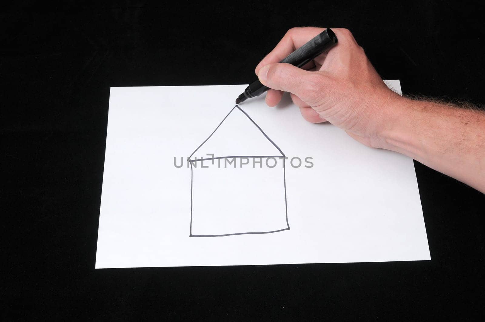 Caucasian Male Hand Drawing on a White Paper