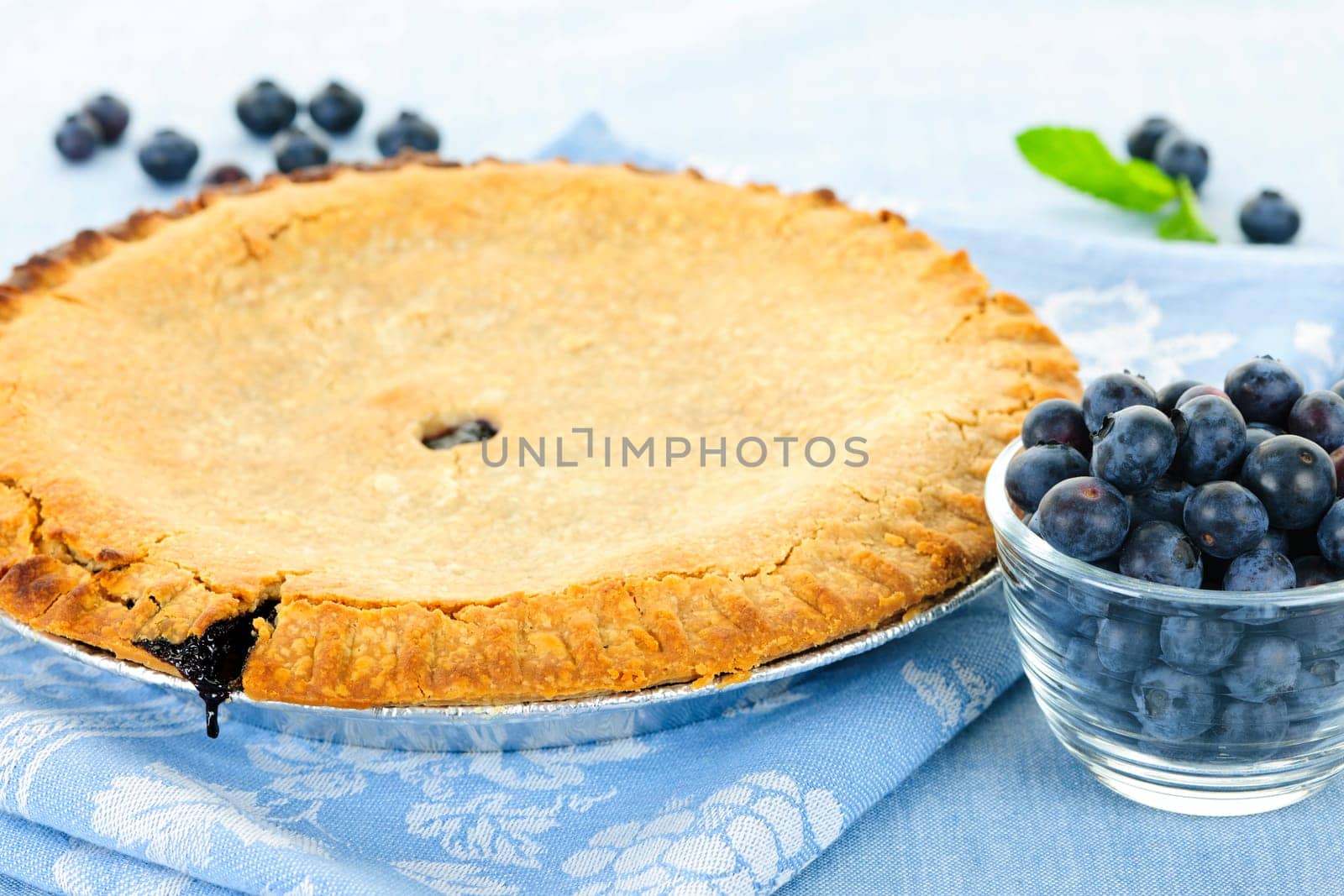Whole baked blueberry pie with fresh  blueberries