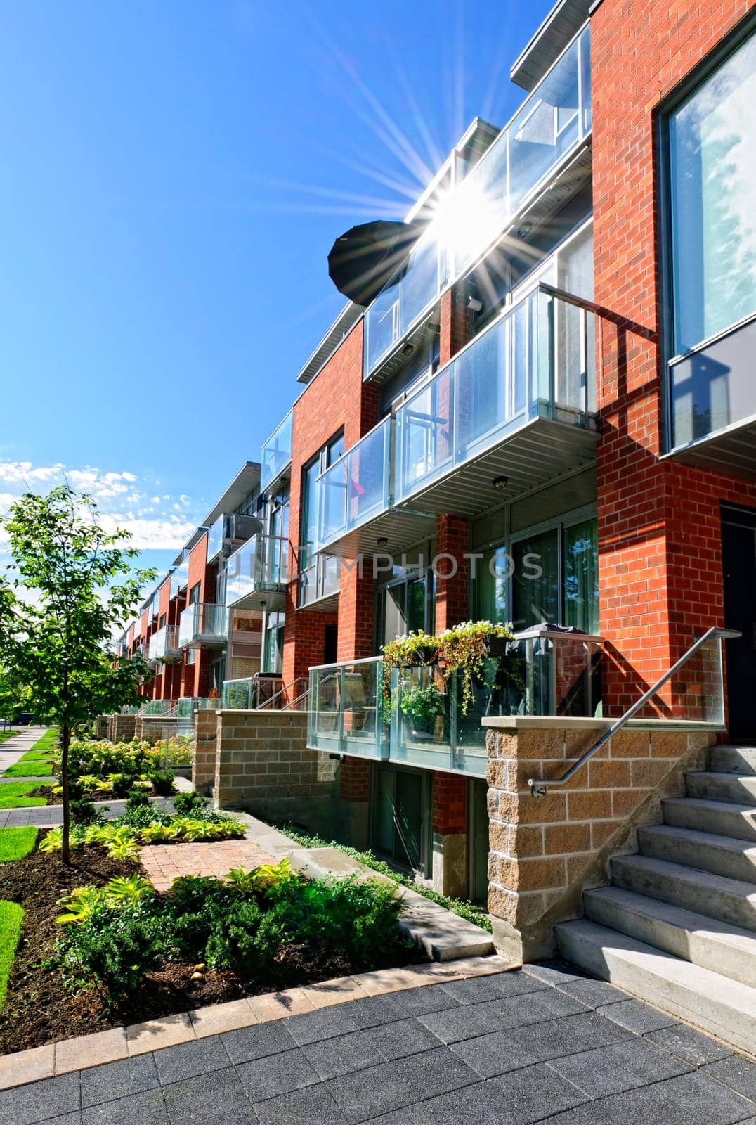 Modern town houses of brick and glass on urban street