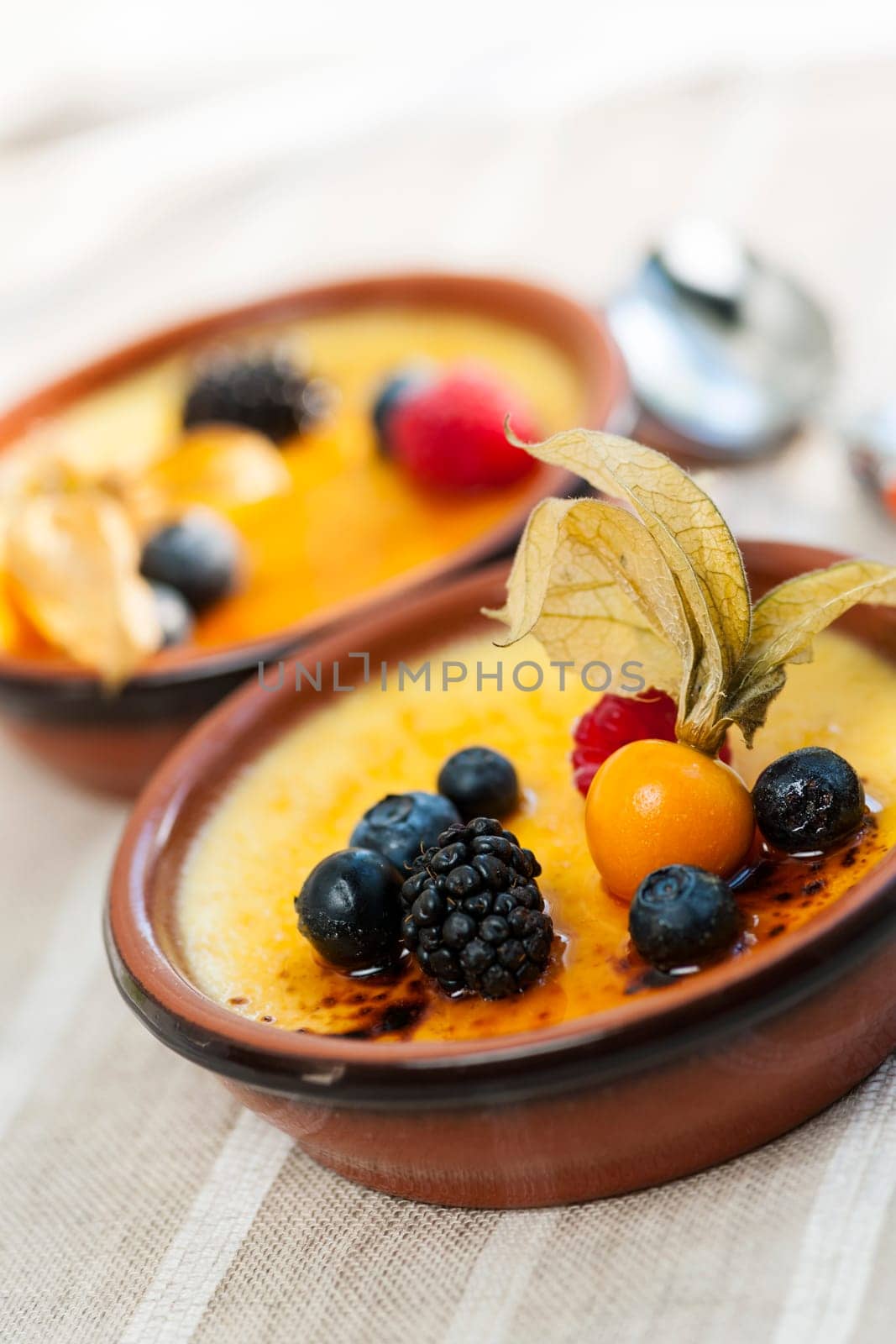 Sweet creme brulee desserts topped with fresh berries