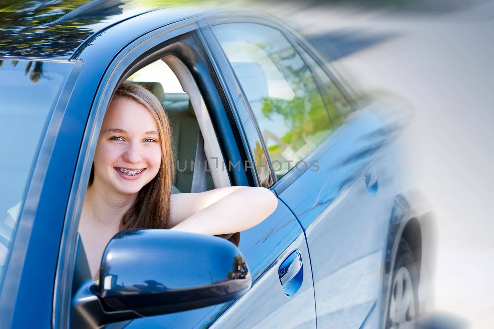 Teenage female driving student learning to drive a car