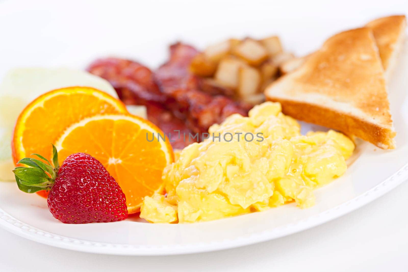 Delicious breakfast of scrambled eggs toast and bacon
