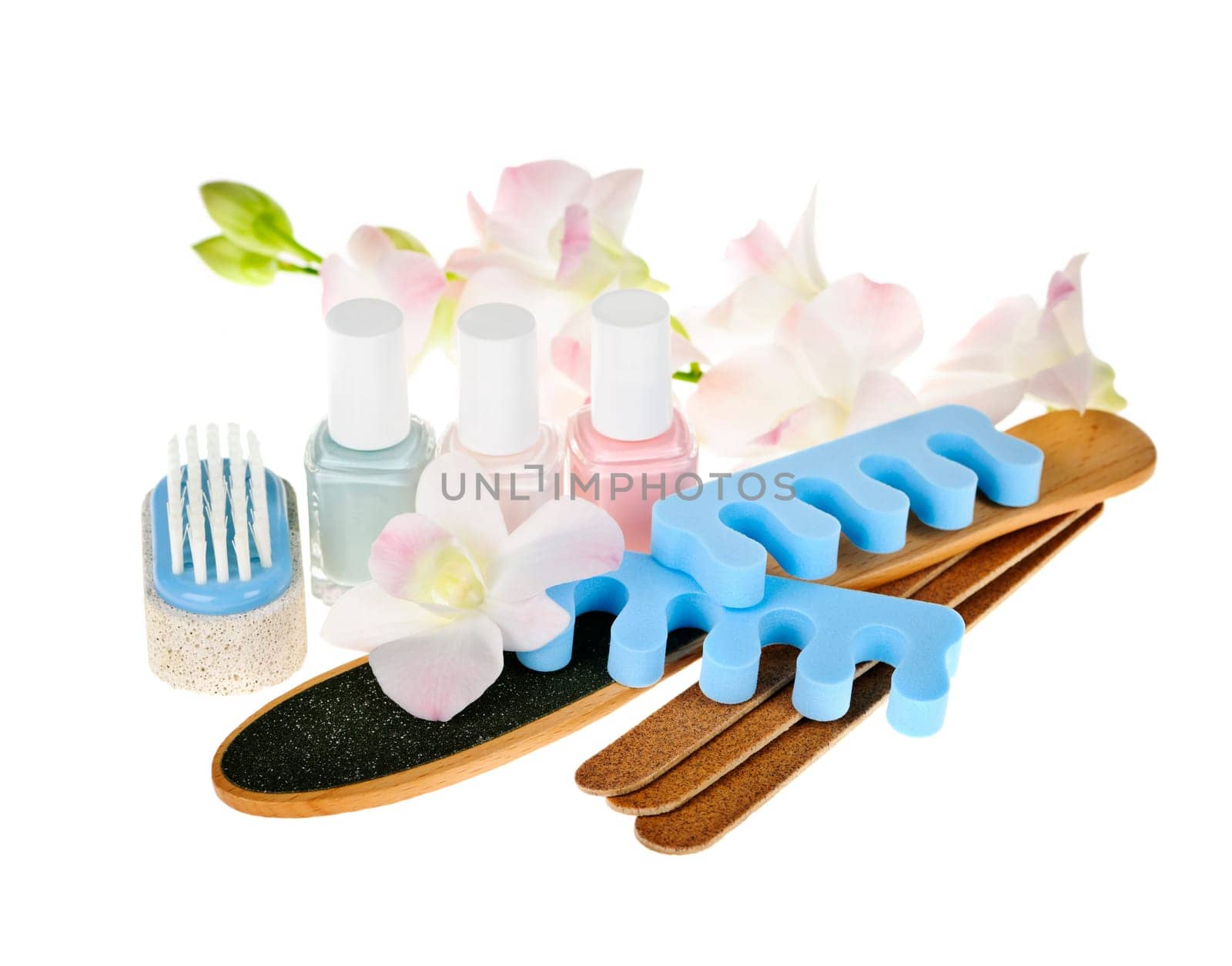 Pedicure accessories and nail polish on white background