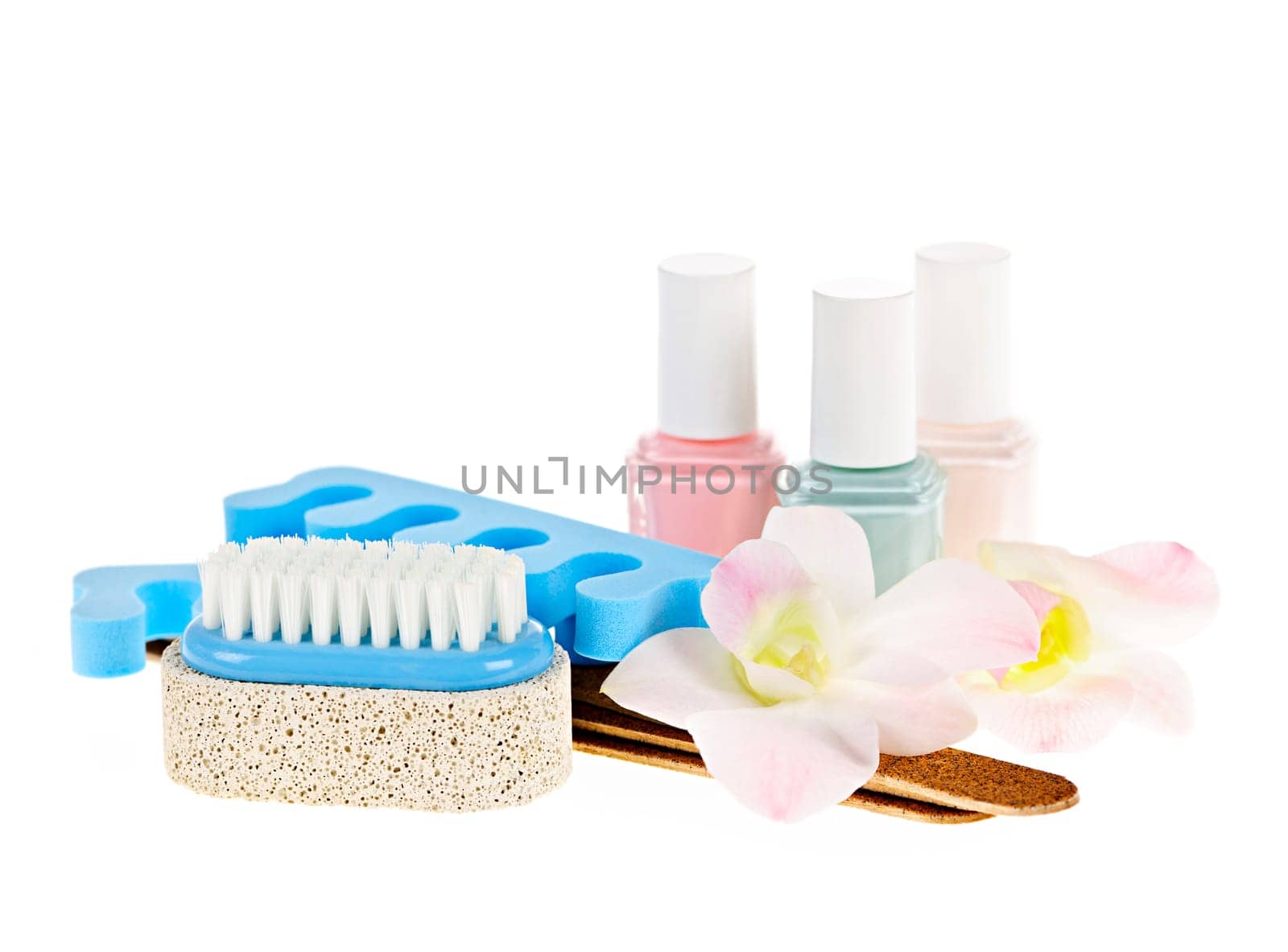 Pedicure accessories with nail polish on white background