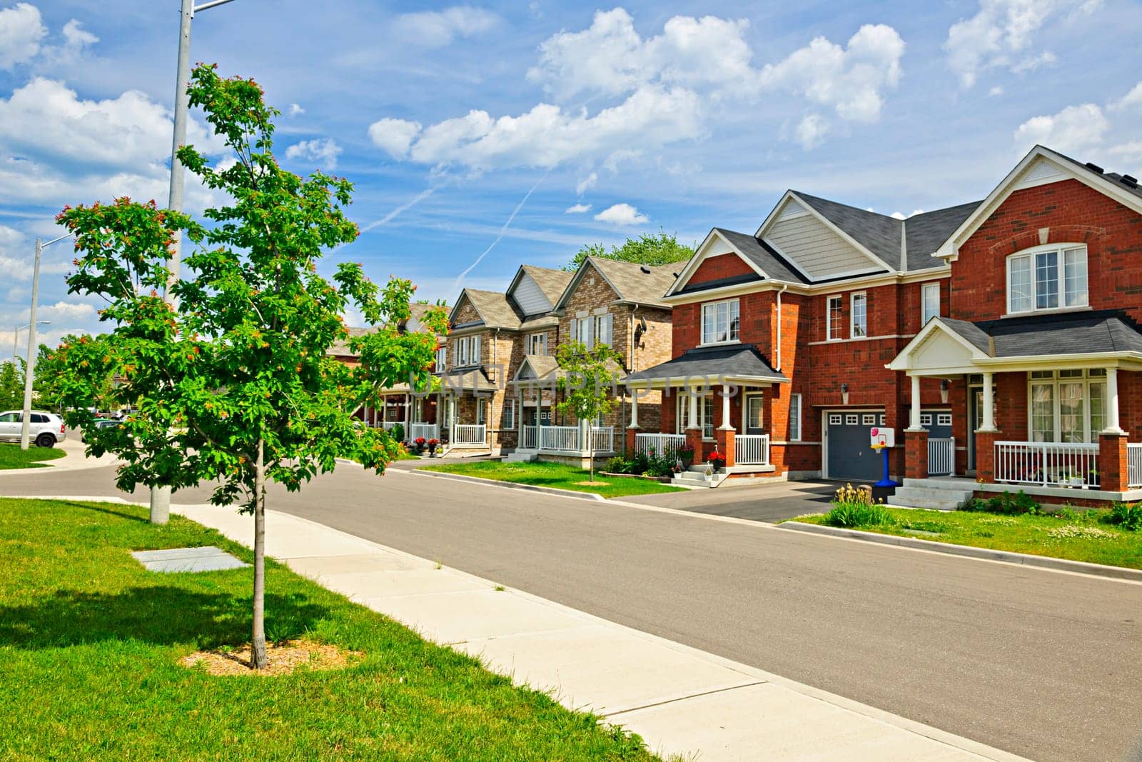 Suburban residential street with red brick houses