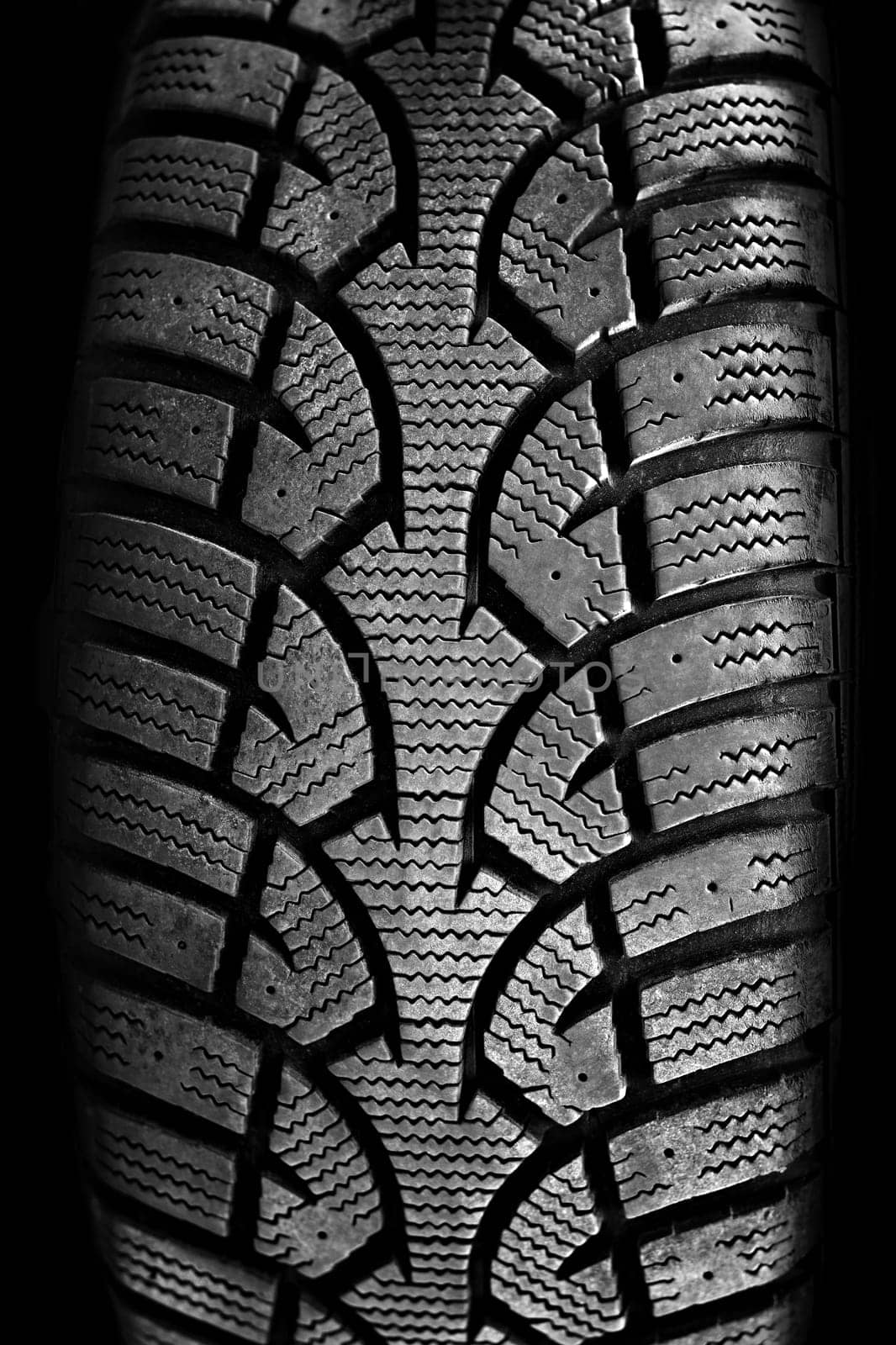Closeup on rubber tire tread of car wheel