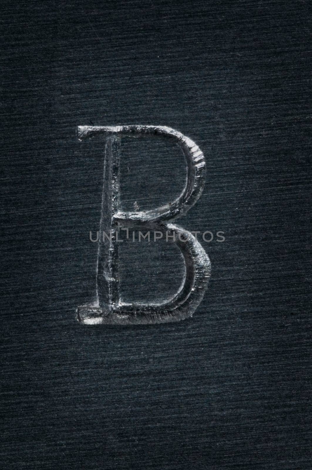 Macro image of the letter "B"" in metal"