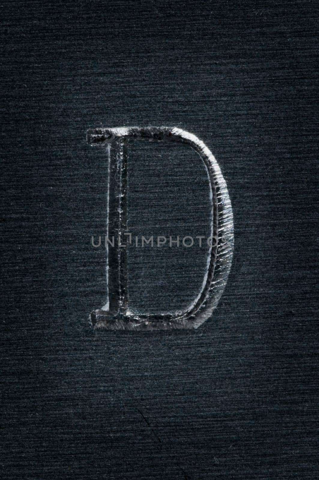 Macro image of the letter "D"" in metal"