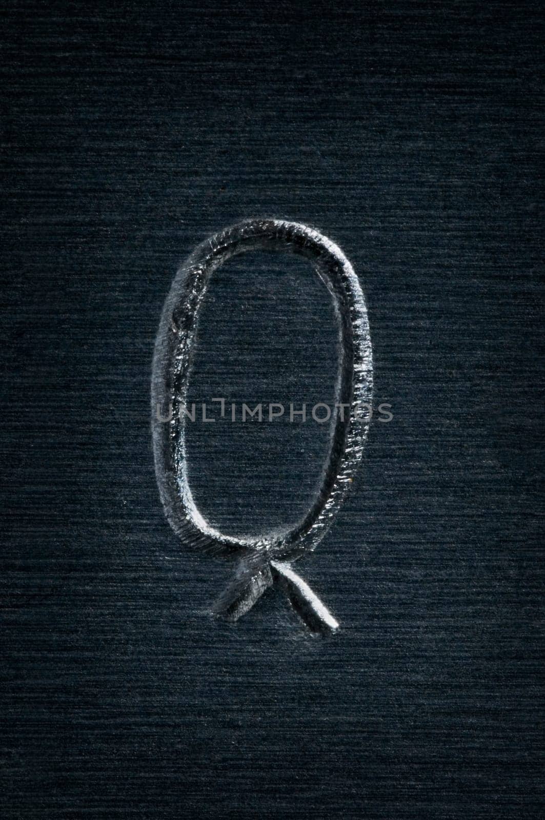 Macro image of the metal letter "Q"""