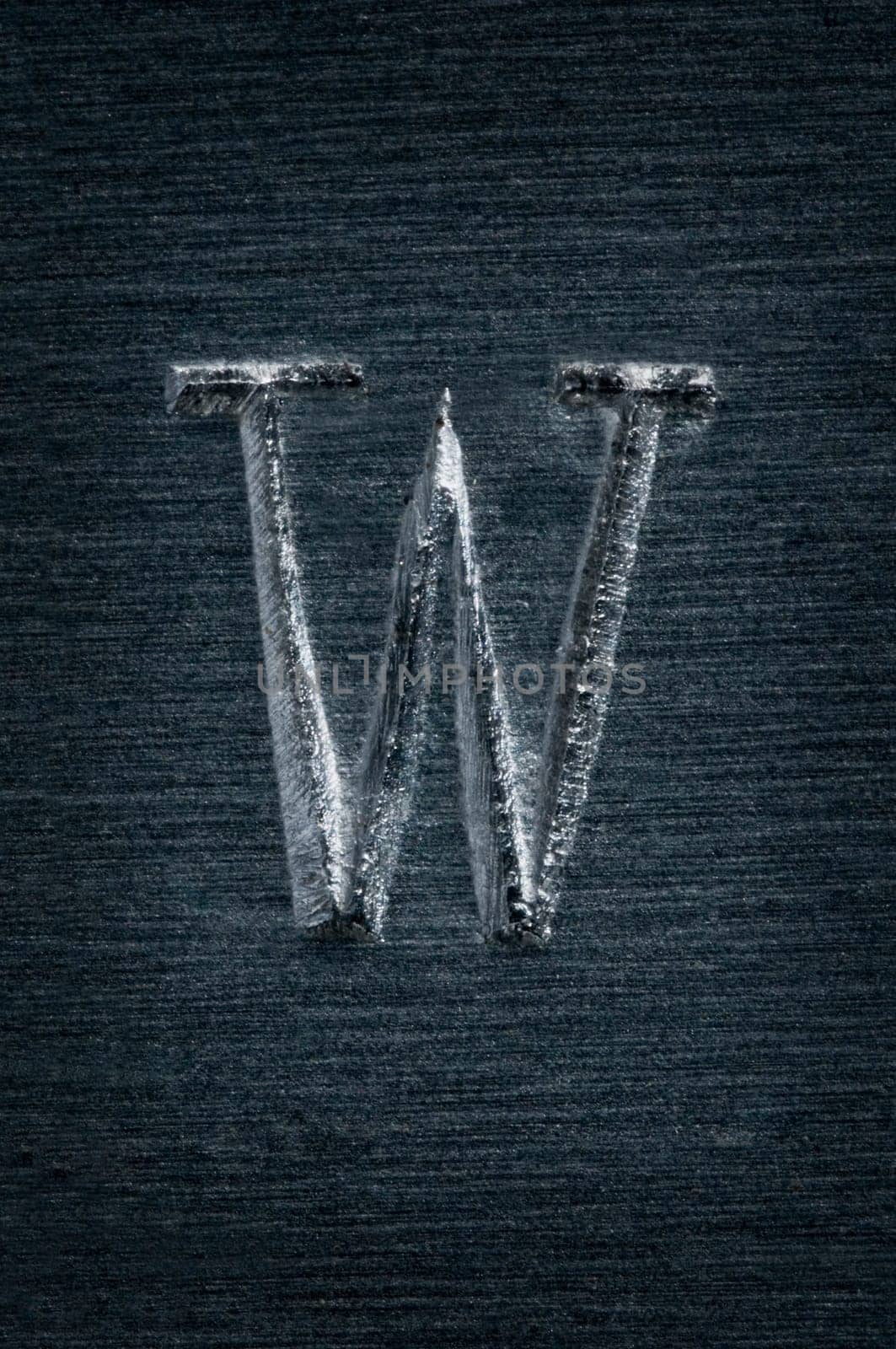 Macro image of the letter "W"" in metal"