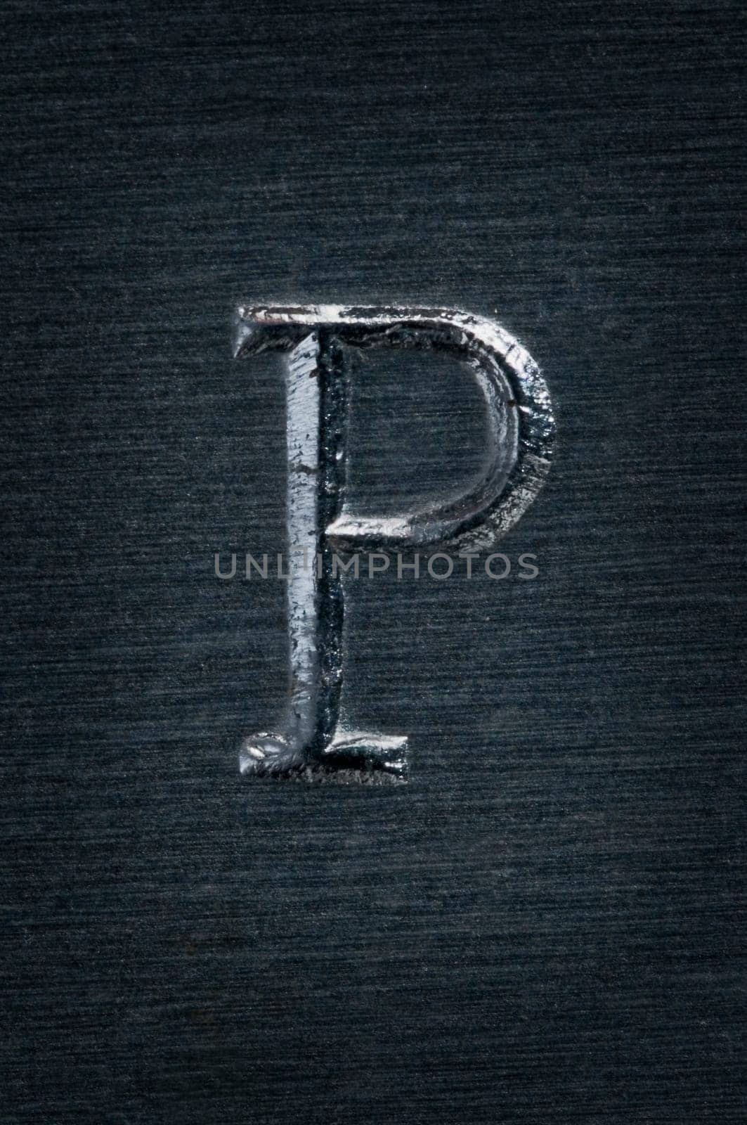Macro image of the letter "P"" in metal"