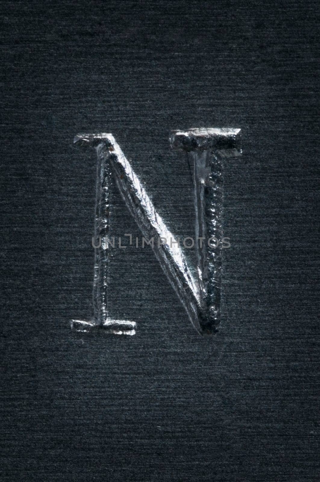 Macro image of the letter "N"" in metal"