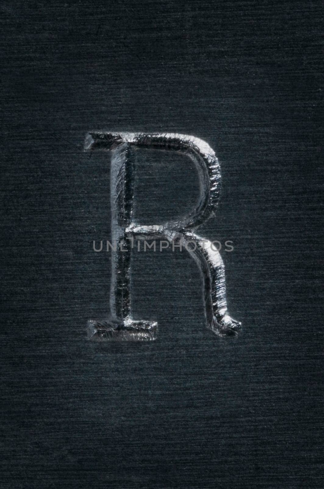 Macro image of the letter "R"" in metal"